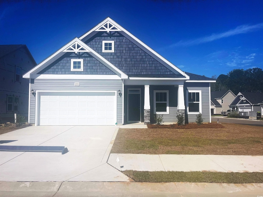 Craftsman-style house with a porch, concrete driveway, a front lawn, and a garage
