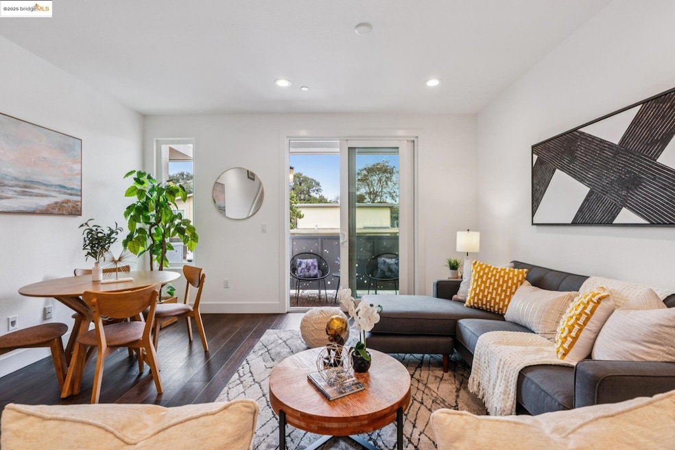 Living area with hardwood / wood-style floors and recessed lighting