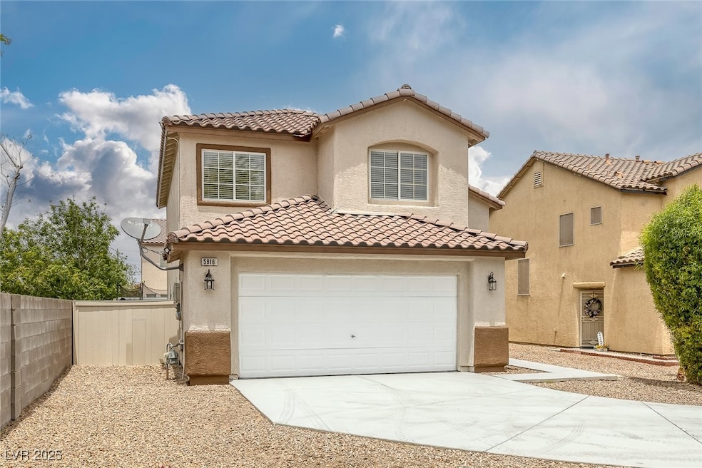 Mediterranean / spanish-style house featuring a ga