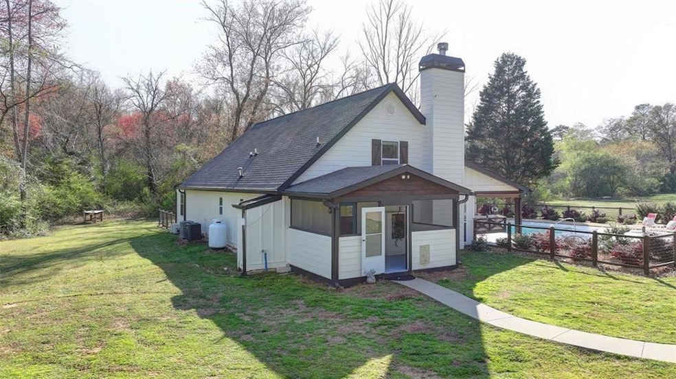 Back of property with fence, a yard, a chimney, an