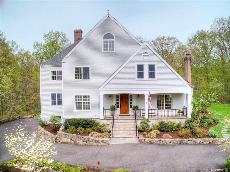 Framed by stone walls and inviting front porch, th