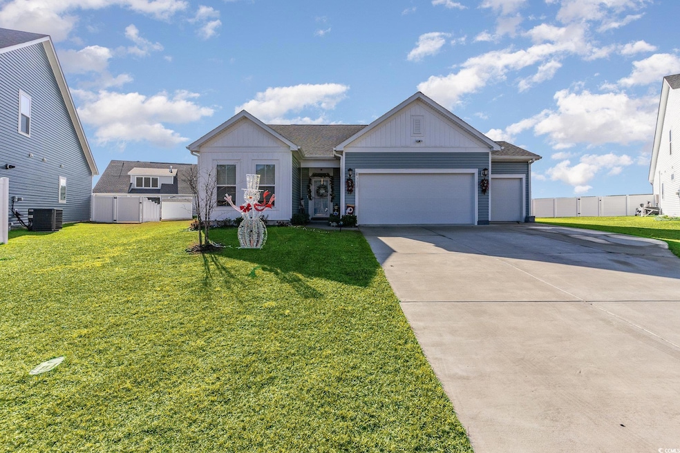 View of front of property featuring board and batten siding, driveway, an attached garage, and a shingled roof