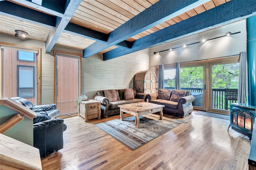 Living area with a wood stove, wooden ceiling with