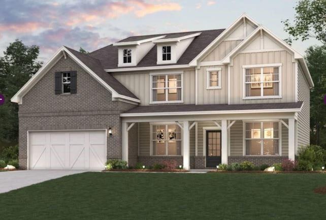 Craftsman house featuring brick siding, board and batten siding, a porch, and driveway