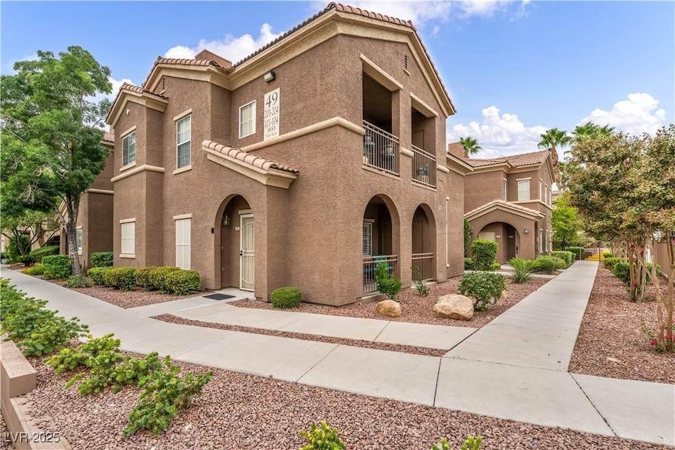 Mediterranean / spanish-style home featuring a tiled roof, a balcony, and stucco siding