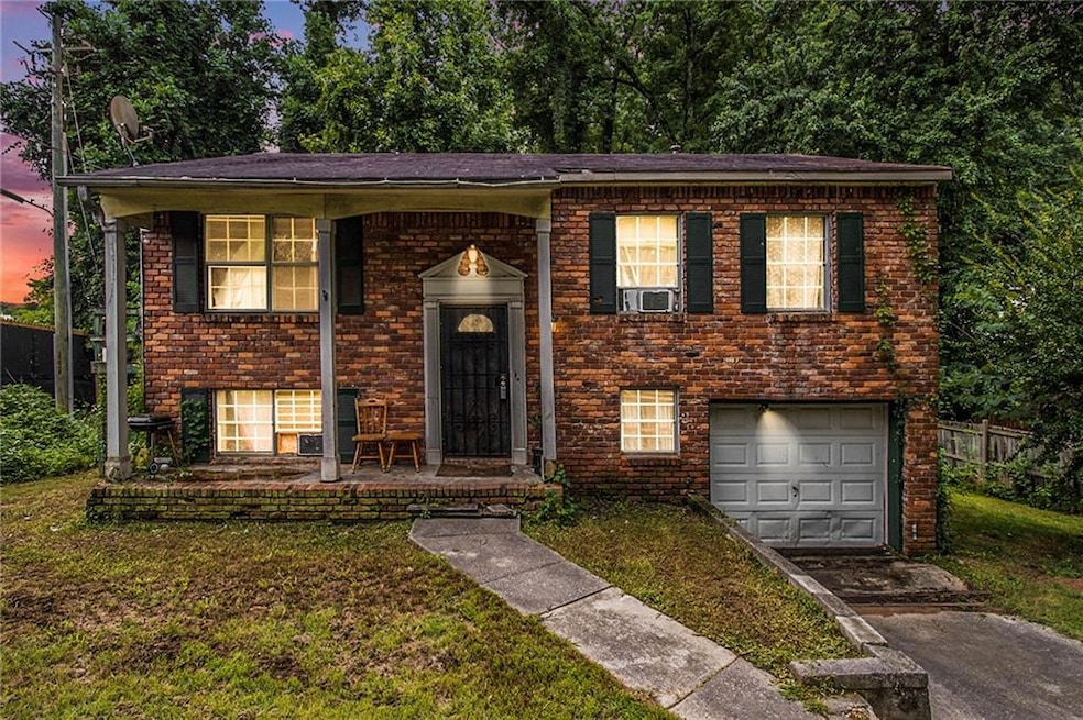 Bi-level home featuring cooling unit, a garage, an