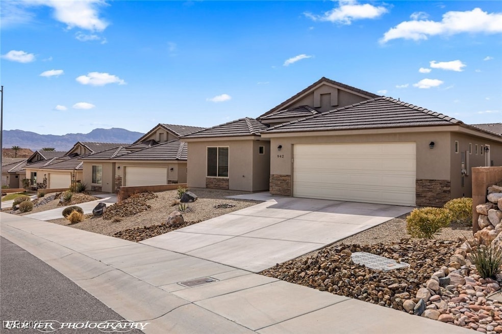 Single story home featuring stone siding, stucco s