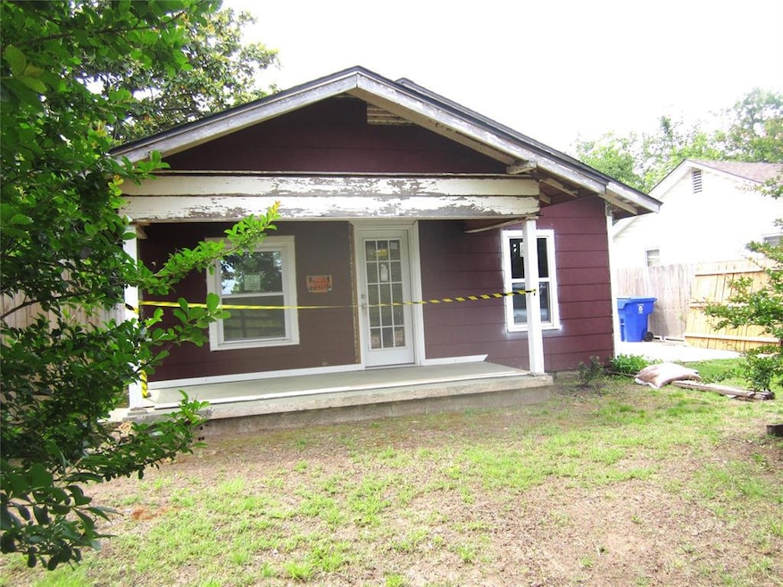 View of front of property with fence and a porch