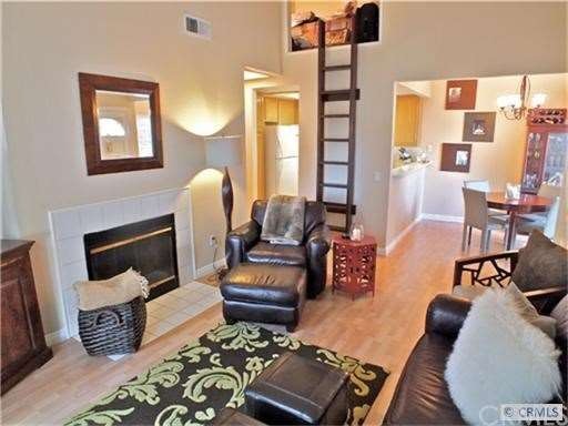 Living room with ladder to loft.