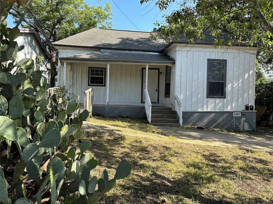 View of front of home with roof with shingles and