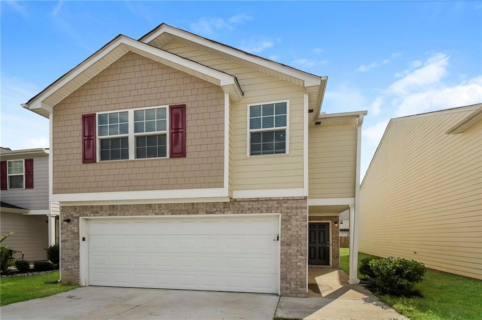 View of front of property with concrete driveway a