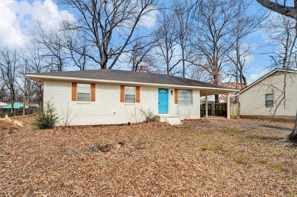Single story home featuring a carport