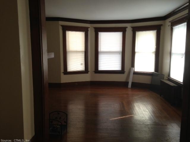 Living Room. Beautiful hard wood floors and many w