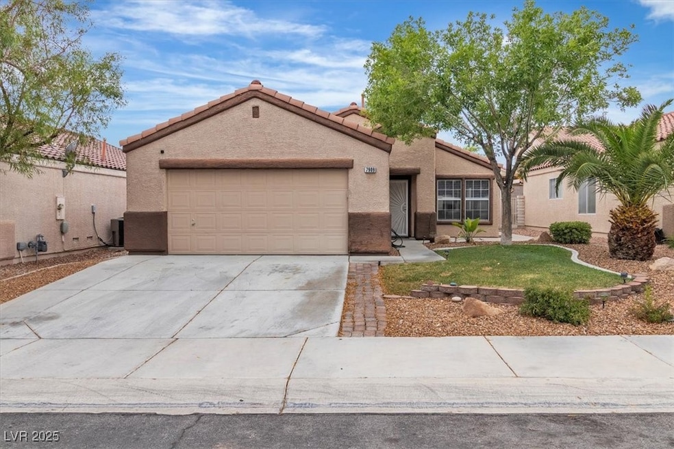 View of front of property with concrete driveway, a garage, stucco siding, and a tile roof