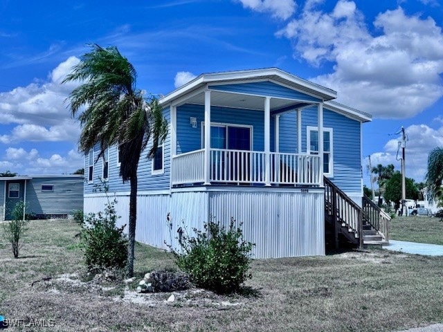 Manufactured / mobile home with stairway and a por