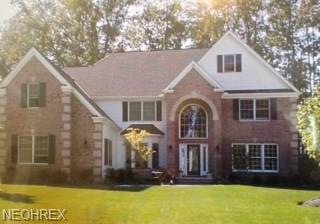 Brick and sand stone quoining on front of home.