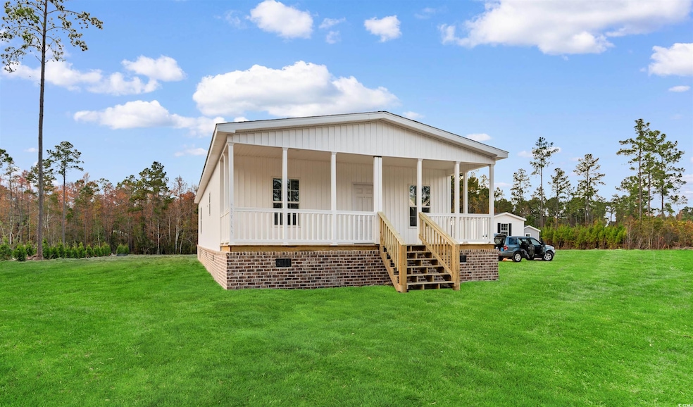 View of front of home with a front yard and a porch