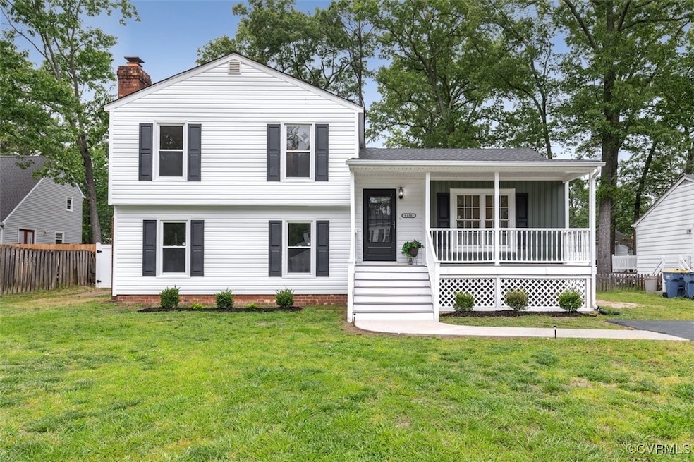 Tri-level home featuring a chimney and a porch