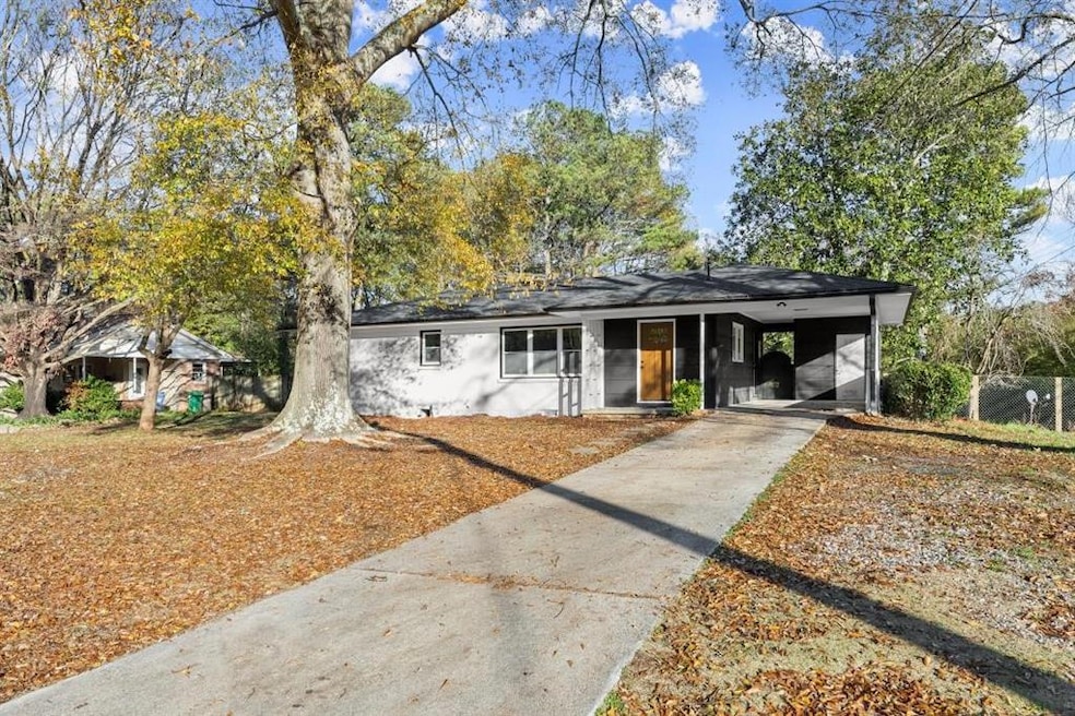 Single story home featuring a carport