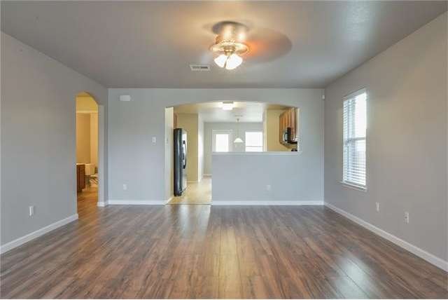 Spacious living area with newly installed wood flo
