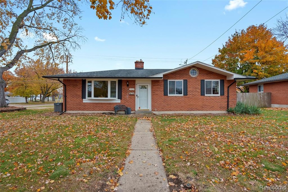 Bungalow-style home with brick siding and a chimney