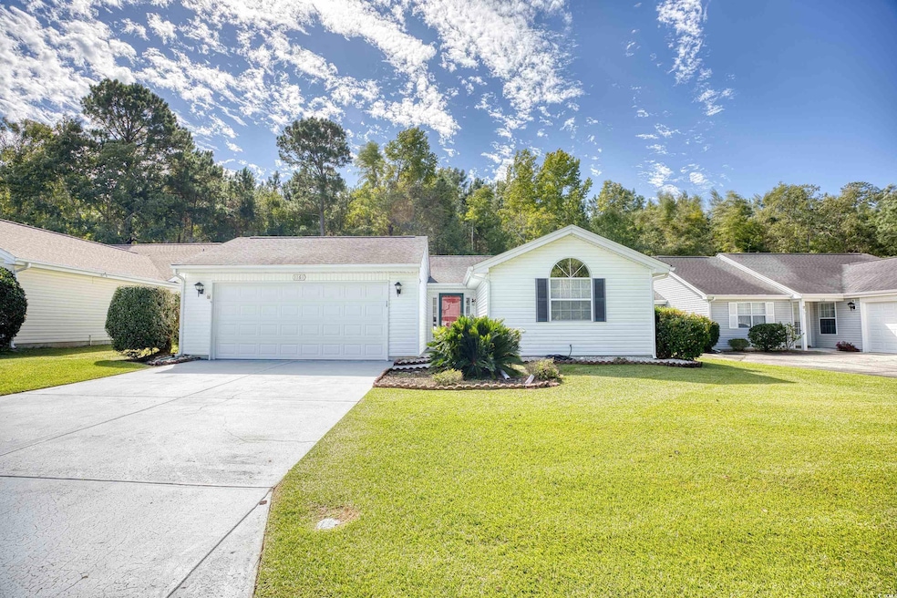 Ranch-style home featuring a front yard, an attach