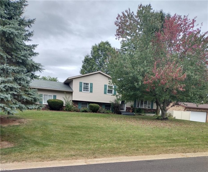 Split level home featuring a front yard