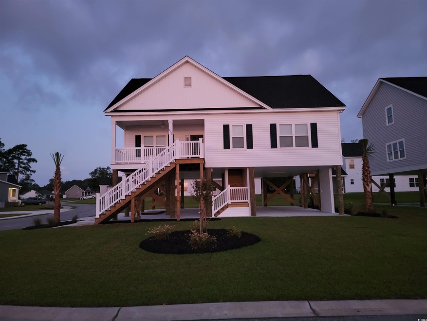 View of front of home with a front yard, a porch, 