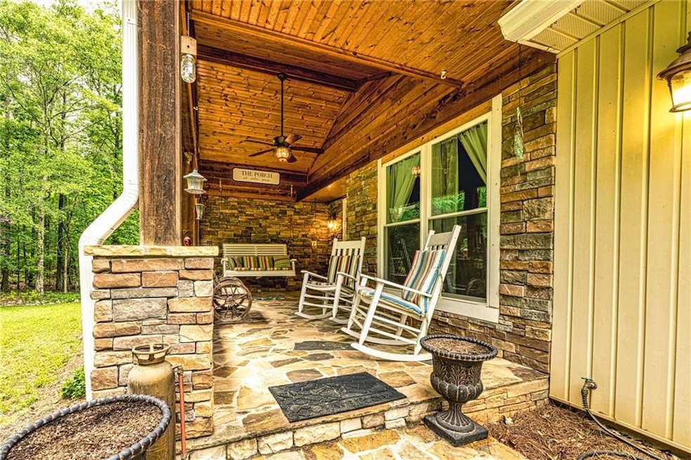 Covered porch featuring a ceiling fan