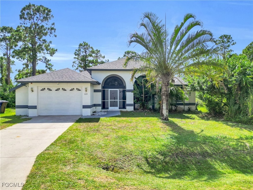 View of front of home with stucco siding, roof with shingles, a garage, and driveway