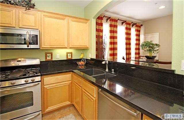 Sleek, rich granite enhances this beautiful kitche