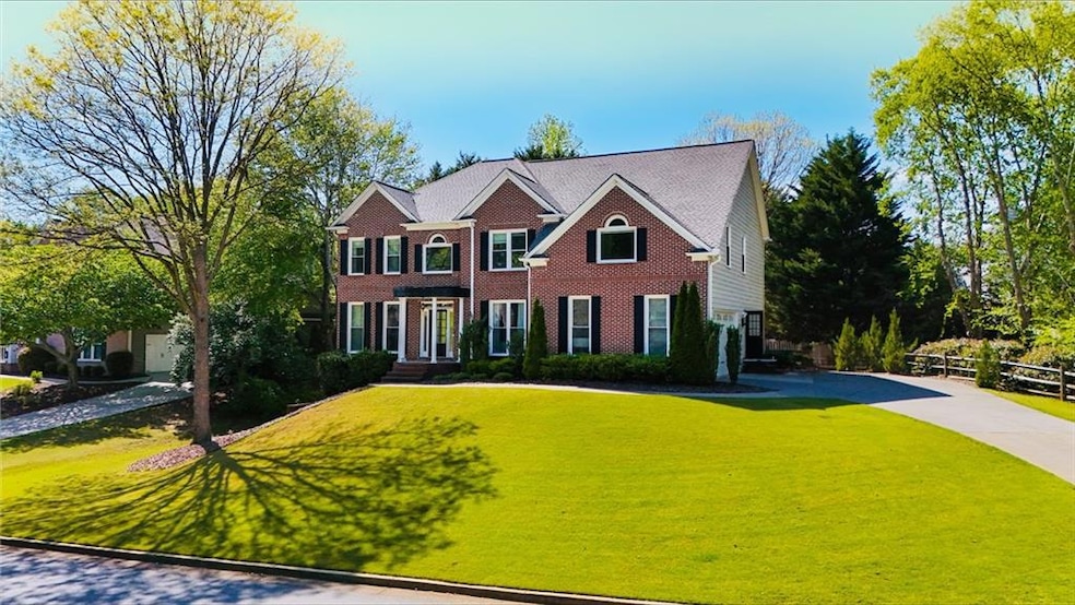 Colonial home with fence, driveway, a front yard, 