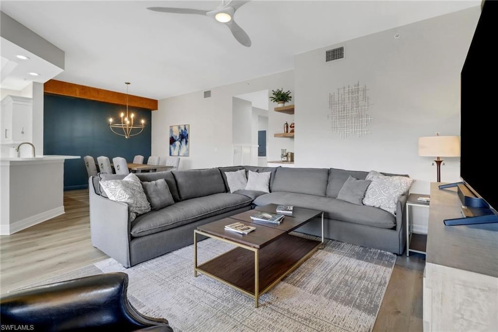 Living room featuring ceiling fan with notable cha