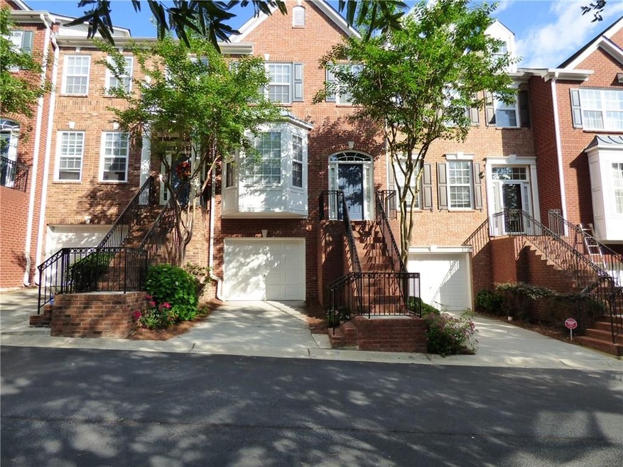 Beautiful brick townhome with one-car garage on qu