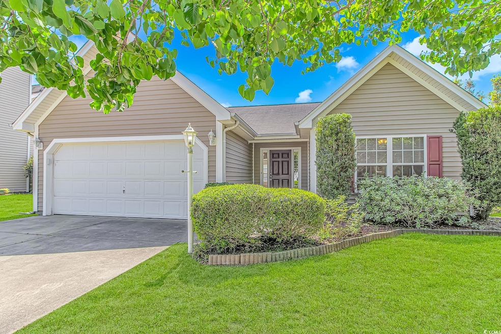 View of front of house with roof with shingles, a front lawn, a garage, and concrete driveway