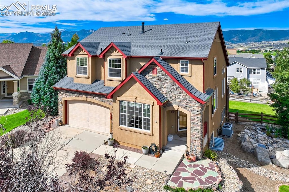 View of front facade featuring stucco siding, stone siding, and a mountain view