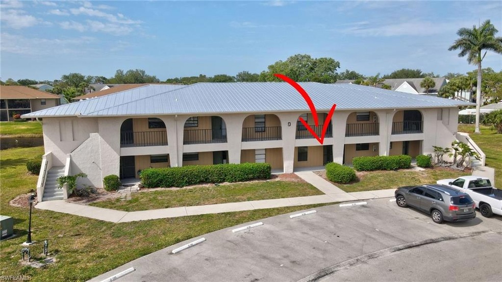 View of property featuring uncovered parking