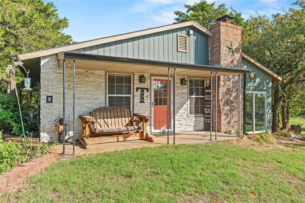 Rear view of property with a chimney, a yard, and a porch