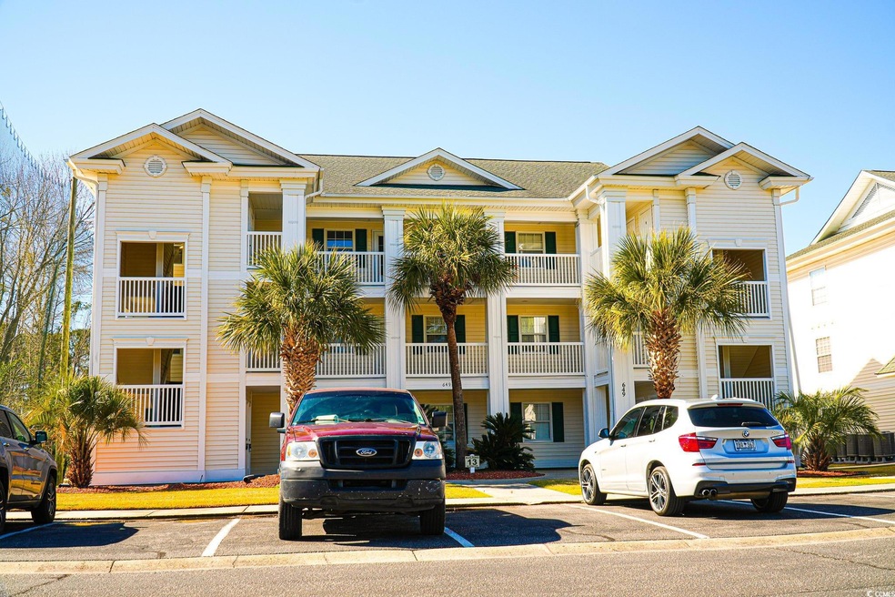 View of property with uncovered parking