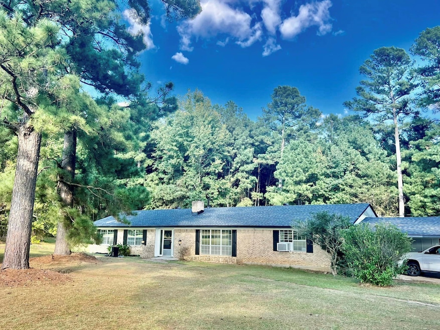 Ranch-style home featuring a front yard