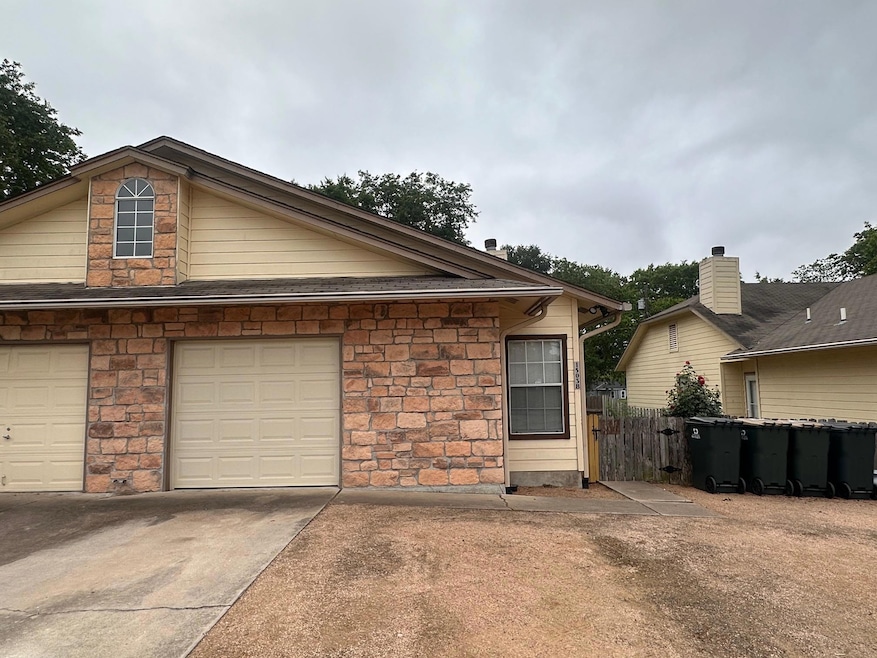 View of front of property with a garage, driveway