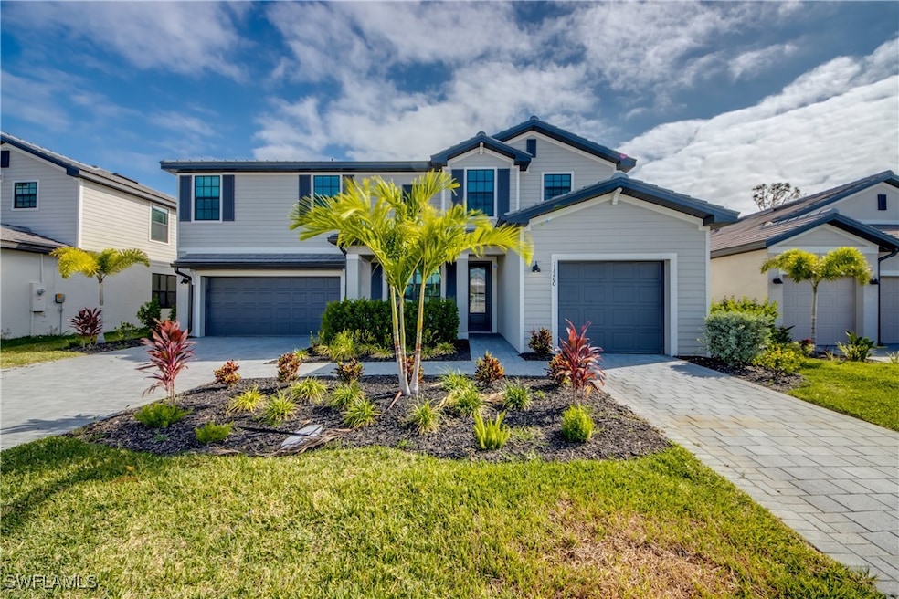 Traditional-style home featuring decorative drivew