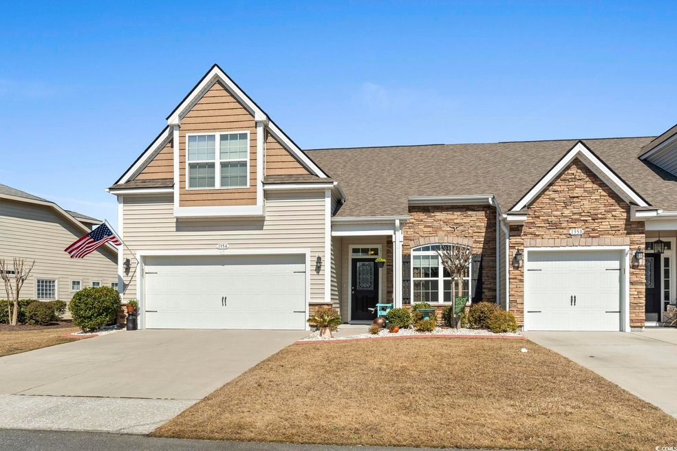 View of front of home featuring driveway, stone si