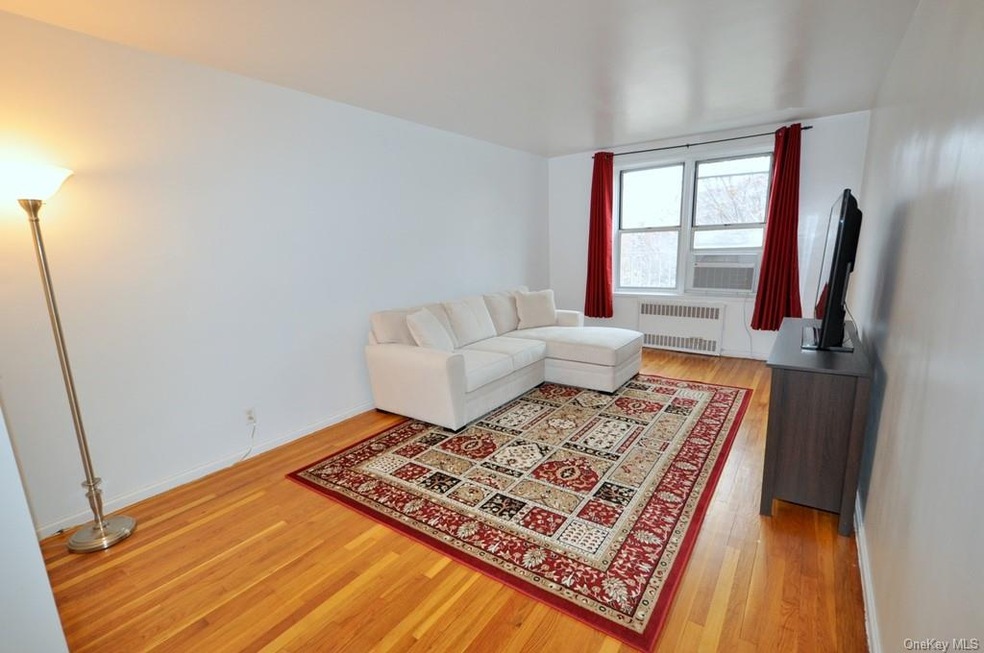 Large living room has hardwood floors and opens to