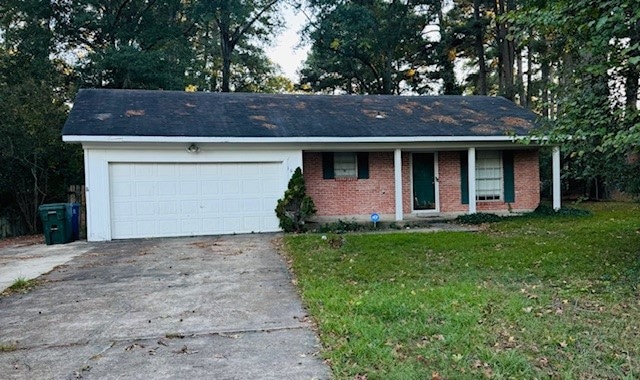 Ranch-style house featuring concrete driveway, a garage, a front yard, covered porch, and brick siding