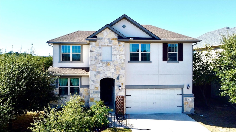 View of front of property with stone siding, a garage, concrete driveway, a shingled roof, and stucco siding