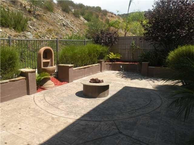 LOVELY SPACIOUS VERY PRIVATE REAR PATIO AREA WITH COLORED STAMPED CONCRETE AND FIRE PIT IS PERFECT TO ENJOY THE OUTDOORS