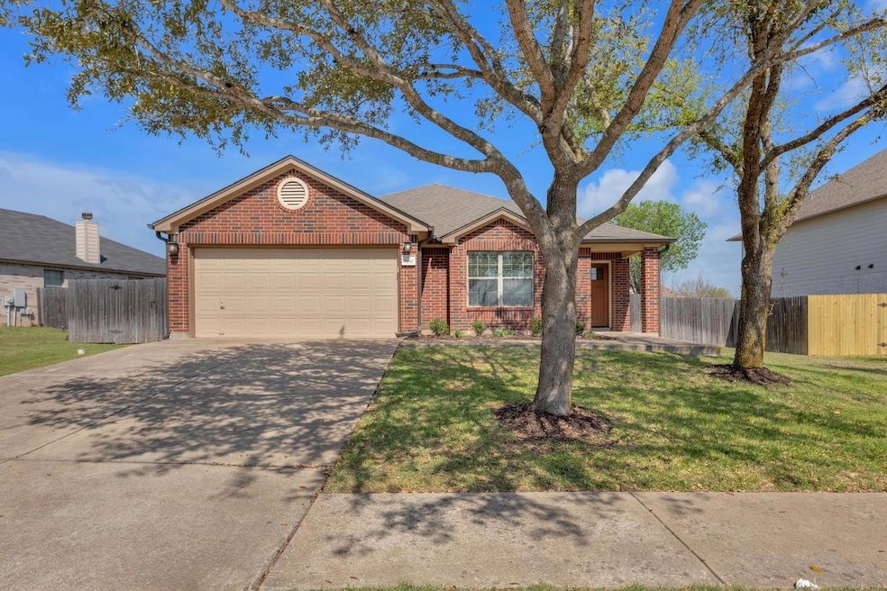 Single story home with fence, an attached garage,