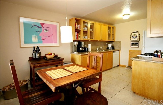 Remodeled kitchen with tile floor, dishwasher, gas