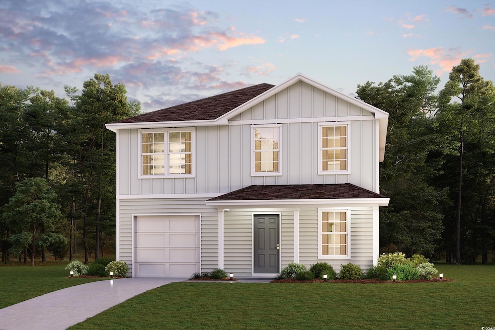 View of front of house with a garage and a yard